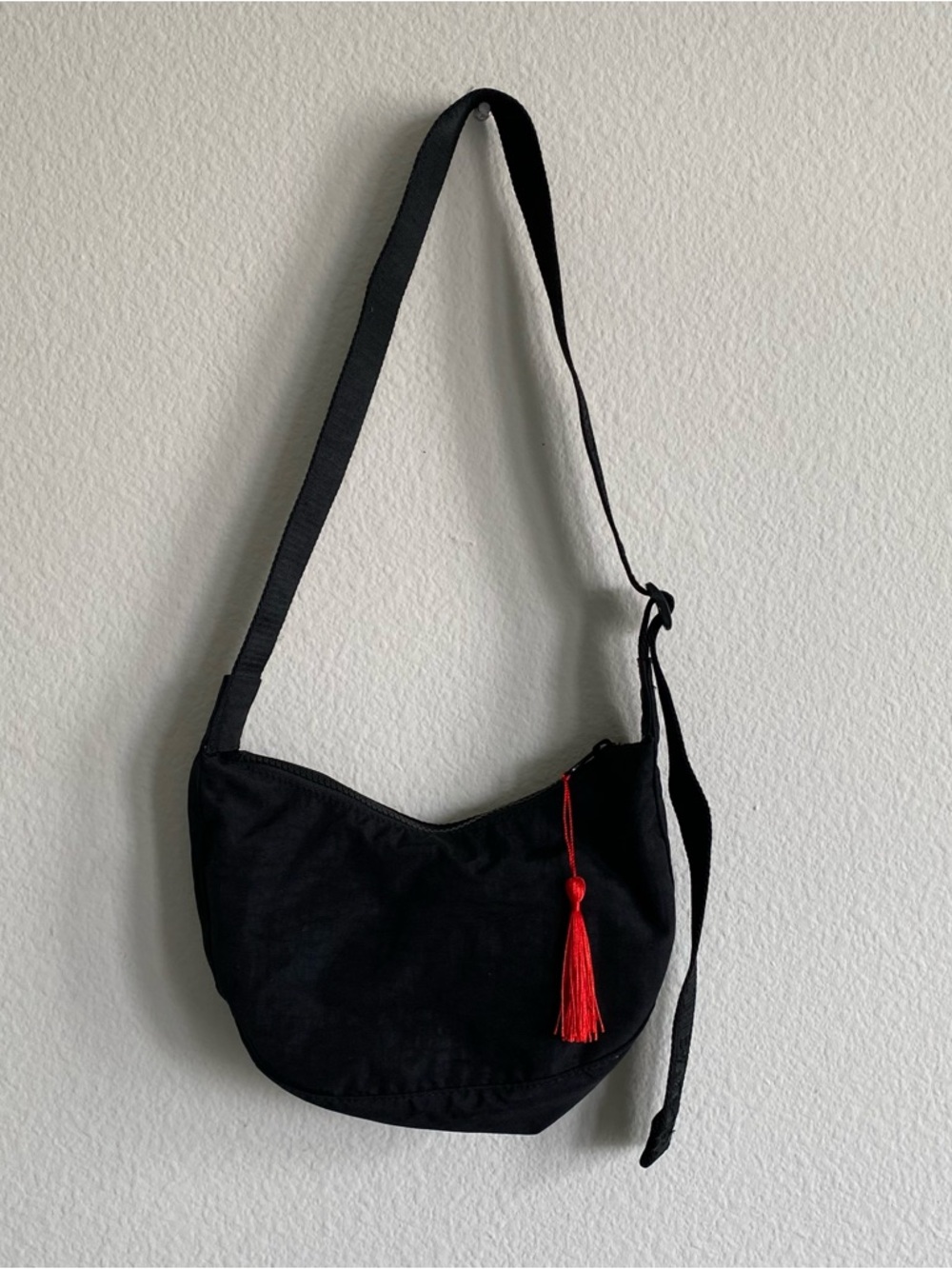 BAGGU Black Nylon Crescent Shoulder Bag with Red Tassel